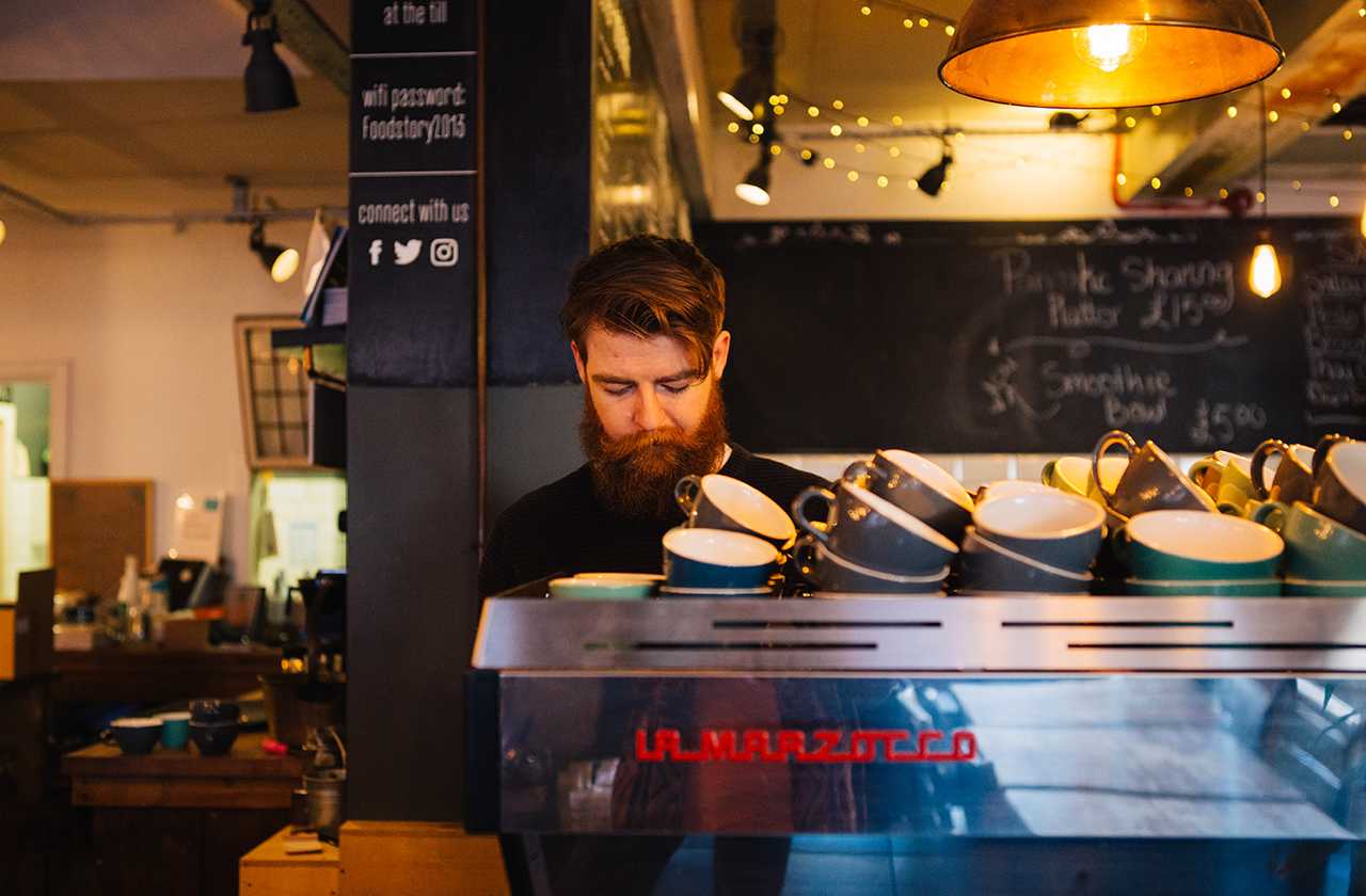 Barista behind a coffee machine