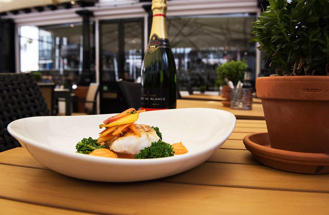 Plate of seafood and bottle of English sparkling wine