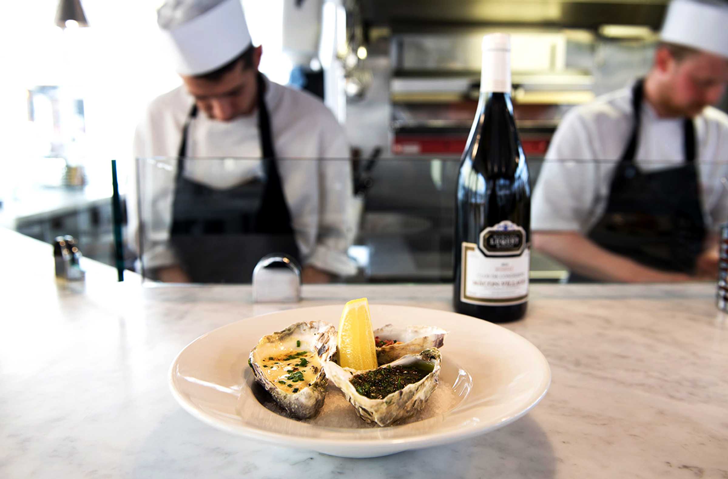 Chefs with a prepared plate of seafood