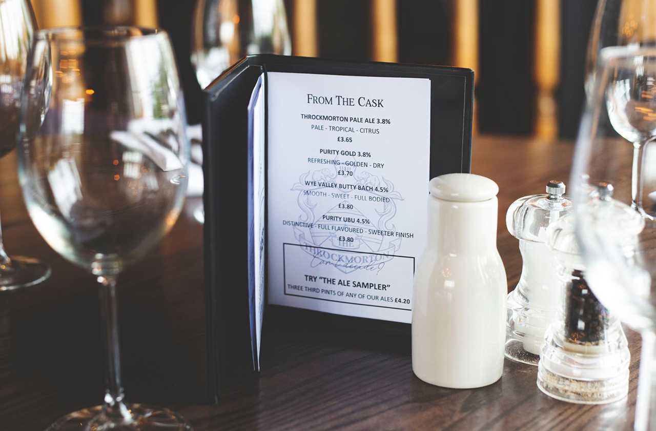 Pub menu on a table with wine glass